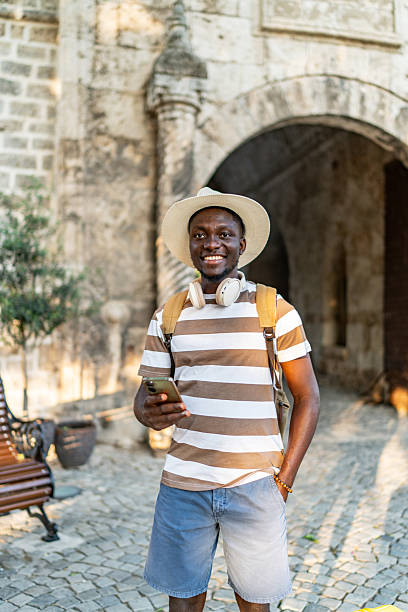 istock Tourist using smartphone in front of ancient building 2220403285