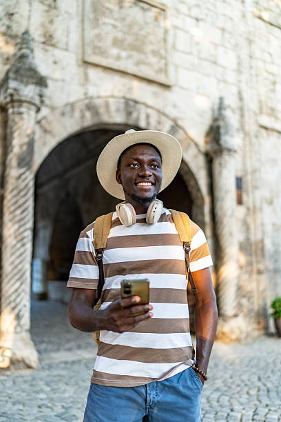 istock Young man exploring a new city using his smartphone 2220403320