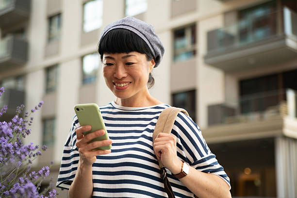 istock Smiling tourist exploring city using smartphone app 2220403505