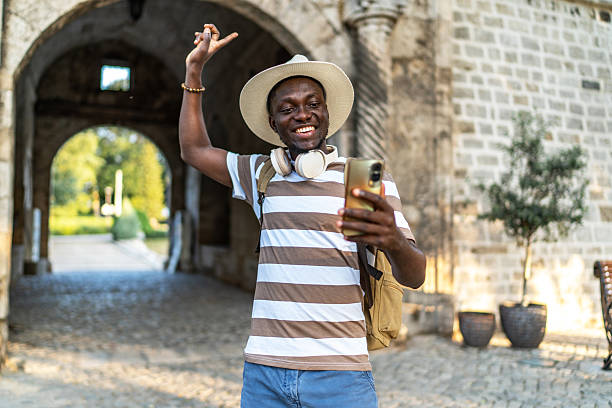 istock Young man dancing and having a video call in a historic place 2220403548