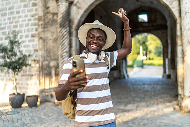 istock Young tourist having a video call while visiting an old building 2220403553