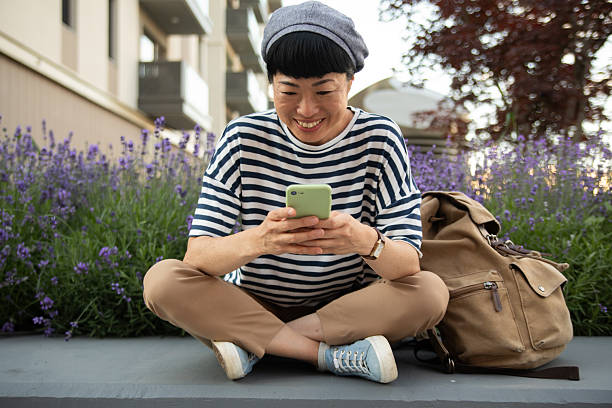 istock Happy tourist using smartphone while relaxing near lavender flowers 2220403702