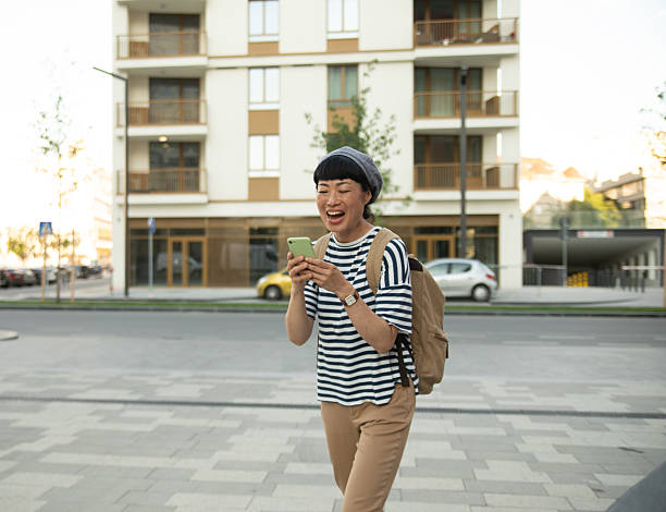 istock Happy tourist walking and using mobile phone in the city 2220403786