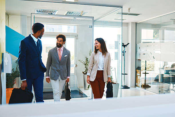 istock Business partners discussing a project while walking through the office 2220403946