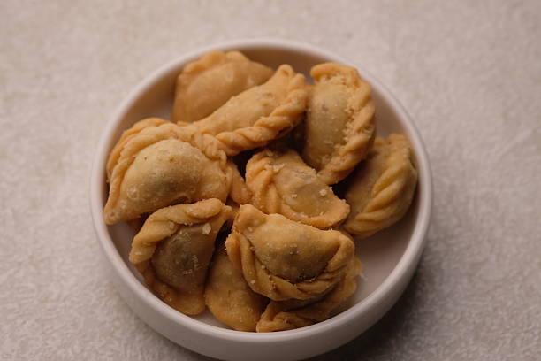 istock mini pastel filled with shredded meat in white plate. savory snack. Pastel abon. 2220405232
