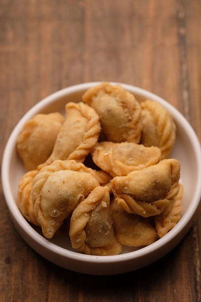 istock mini pastel filled with shredded meat in white plate. savory snack. Pastel abon. 2220405240