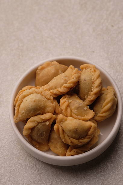 istock mini pastel filled with shredded meat in white plate. savory snack. Pastel abon. 2220405255