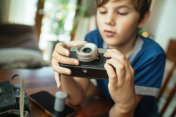 Boy with retro camera at home