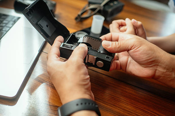 istock Man showing old retro camera to his son 2220405578