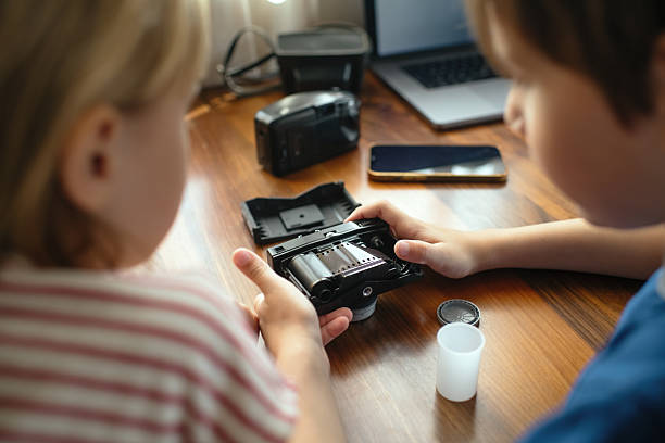 Boy and girl with retro camera at home