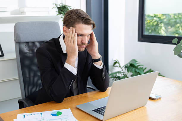 istock Caucasian businessman grab his head suffer from headache 2220406282