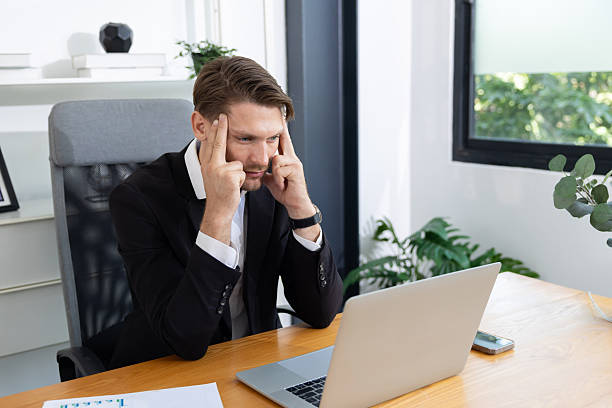 istock Caucasian businessman grab his head suffer from headache 2220406286