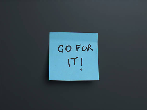 istock Motivational sticky note on desk encouraging action 2220407520