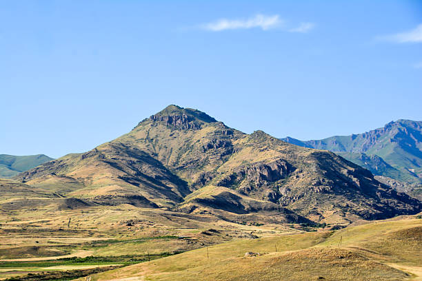istock High beautiful mountain. Beautiful mountain landscape. Mountain peak and green fields. Green nature and trees 2220409611