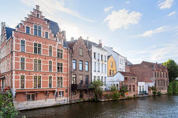 istock Historic brick residential buildings along a river under clear sky with clouds at sunset 2220412505