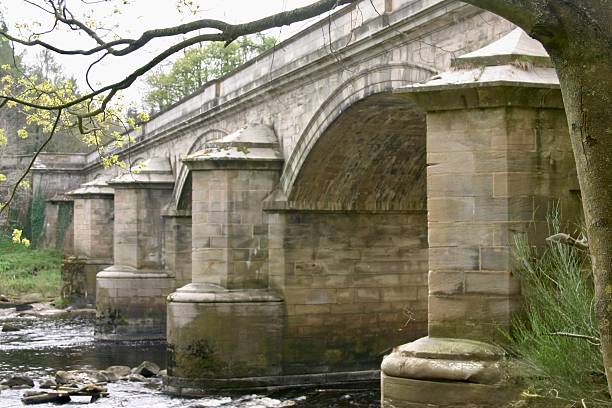 istock Large stone bridge over the river with arches 2220413590