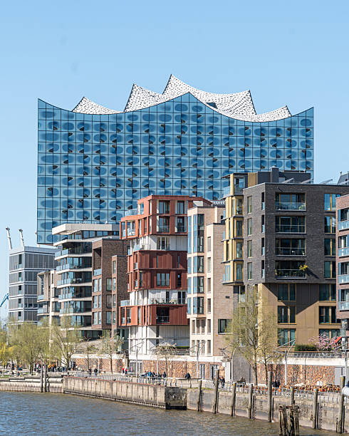 Hamburg, Germany, 2025-04-07:View of houses in the Hafencity in Hamburg, behind it the Elbphilharmonie stands out, vertical
