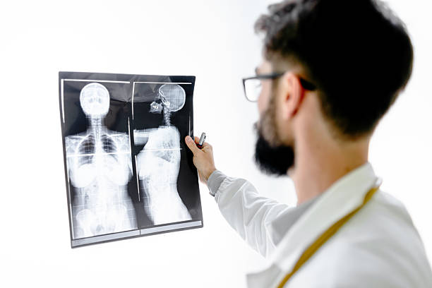 Doctor in medical office checking x-rays