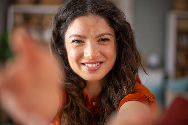 istock Smiling young woman reaching out for a hug 2220418403