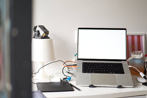 istock Laptop showing blank screen on desk with graphics tablet and lamp 2220419866