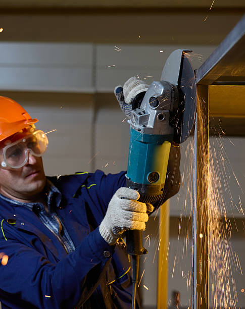 istock Male Builder grinding welds on metallic construction, focus on the working tool 2220420131