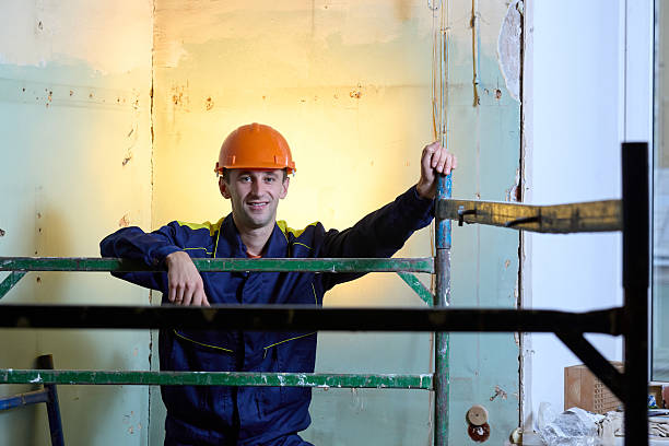 istock Portrait of smiling young man worker in protective workwear 2220420343