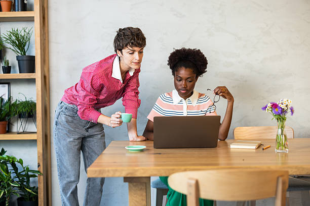 istock Two young businesswomen collaborating on a laptop in a modern office 2220420563