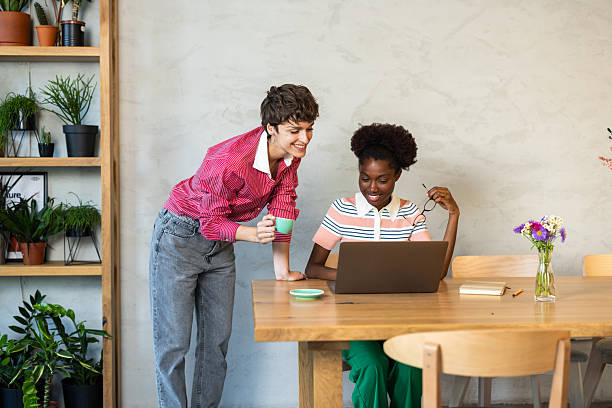 istock Two young businesswomen collaborating on a laptop in a modern office 2220420574