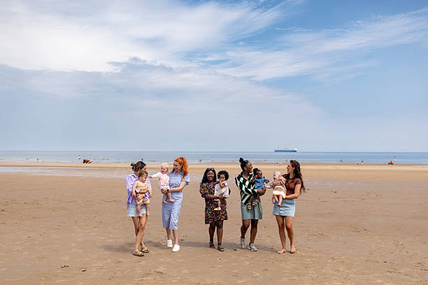 istock Mothers and their Children at the Beach 2220421652