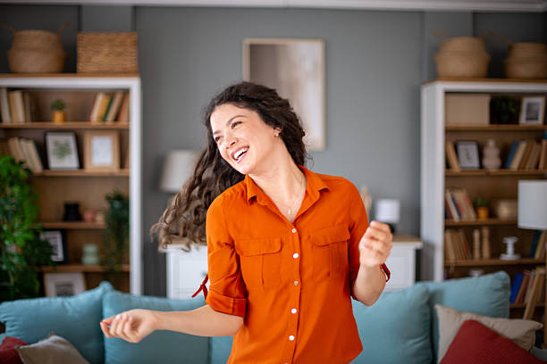 istock Happy young woman dancing and having fun at home 2220422585