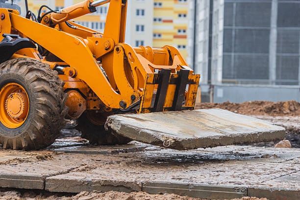 Loader transports concrete slabs. Build road