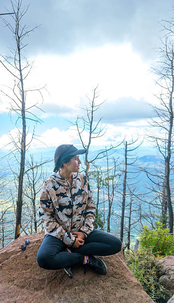 istock Hiker sitting on a rock contemplating the view after a wildfire 2220424970