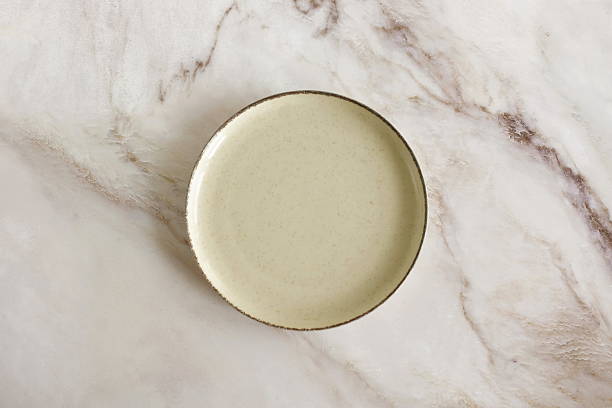istock Plate mockup neutral colors on beige marble background top view with copy space 2220428411