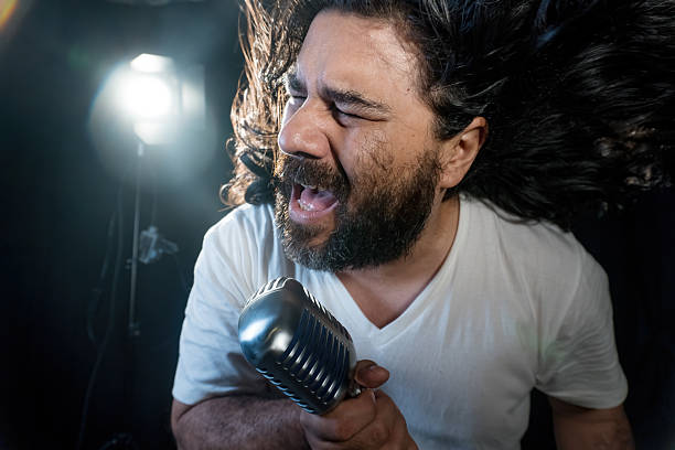 istock Energetic singer performing with passion on stage 2220428719