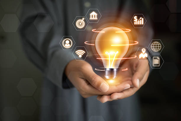 istock A person is holding a light bulb in their hand. The light bulb is surrounded by various icons, including a person, a bank, a book, and a globe 2220429270