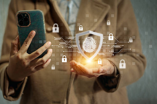 istock A woman holding a smartphone with a shield and fingerprint hologram, emphasizing biometric security. 2220429486