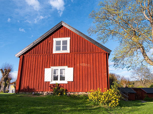 Sun and barn side nostalgic look at rural America. Gabled end of barn building with blazing sun above with copy space.