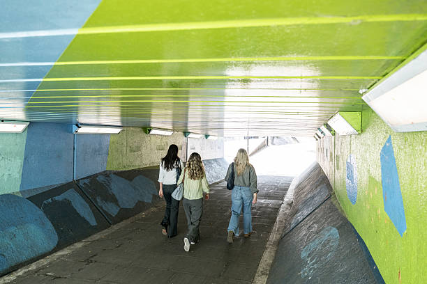 Sunlight illuminating a colorful wall under a bridge in east london