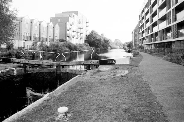istock Canal lock gates and modern housing development in london, uk 2220433364