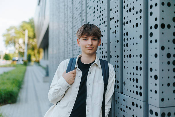 istock Teen Student Outside School Building in Light Jacket on a Bright Day 2220434418