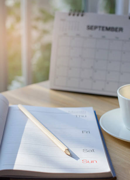 istock Diary, Calendar and agenda for Event Planner to plan timetable, appointment, organization, management on office table. Desktop Calender and coffee place on wooden desk. Calendar Background Concept 2220435168