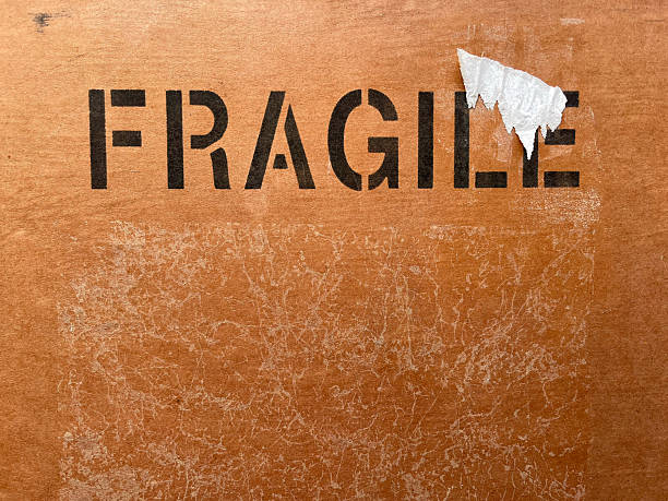 Fragile icon on wooden background. Broken glass sign. Part of a series. Underground, grunge, vintage style of interior. Post office background. Delivery service signs. Copy space. Rustic rural texture