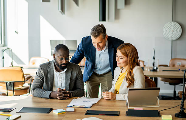 istock Business team analyzing financial reports in modern office 2220437690