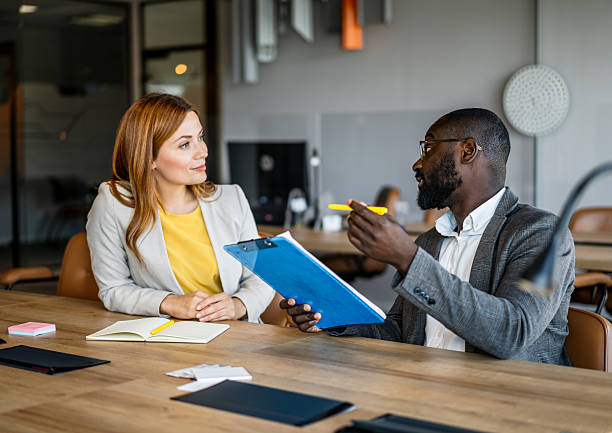 istock Two businesspeople having a meeting in a modern office 2220438246