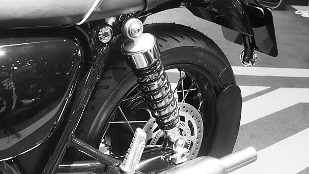 istock A motorcycle's rear suspension system, highlighting the shock absorber and coil spring 2220442306