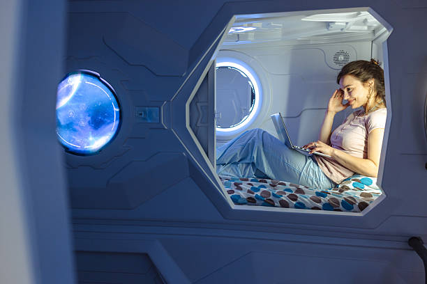 istock Woman using a laptop inside a cozy futuristic sleeping pod 2220443103