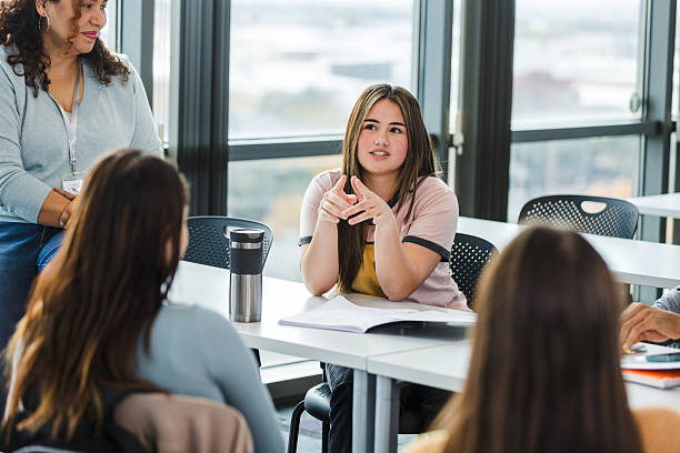 istock Young Woman Leading a Group Discussion in a Classroom 2220444527
