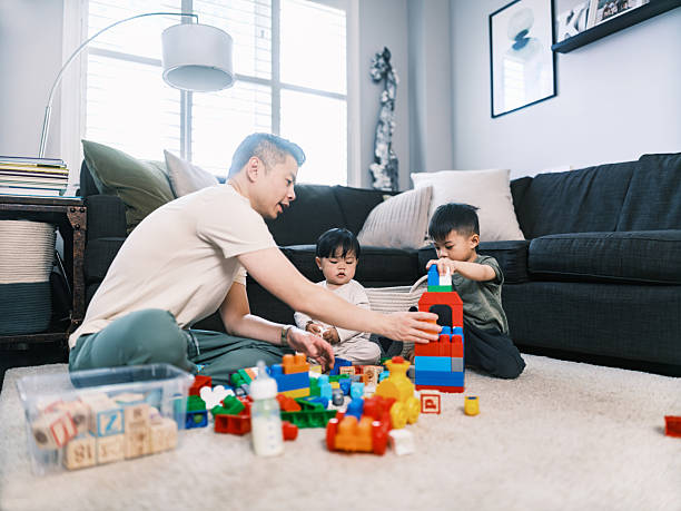 istock Young Korean Father at Home playing with 2 toddler sons 2220446216