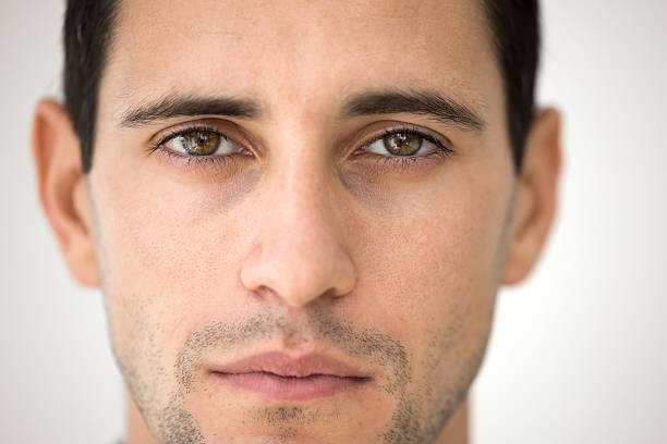 Close up portrait handsome young male face looking at camera