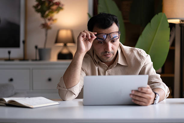 istock Man Writing in a Notebook at a Desk 2220453258
